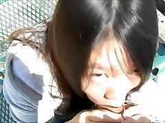 Japanese woman deep throating guys in the park in broad day light