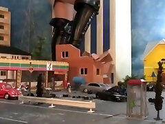 sexy giantess stomping city in high high-heeled shoes and boots