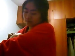 Asian girl with big funbags changes clothes in her bedroom