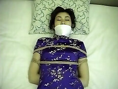 Chinese dress woman trussed up and gagged