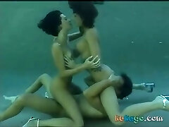 Underwater lovemaking with two hot brunettes