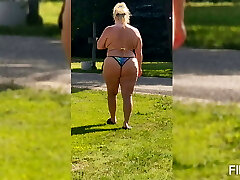 She is mowing in a panty.