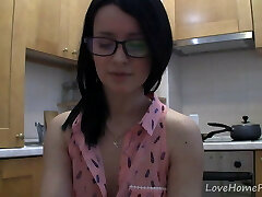 Splendid teen with glasses talking in the kitchen