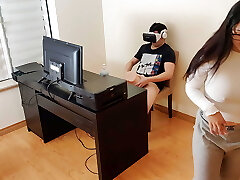 Hot step-mother masturbates next to her son while he watches porn with virtual reality glasses