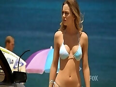 Leighton Meester climbing up a ladder out of a pool looking