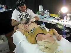 Blond bimbo moans with pain as her pubis was being tattooed