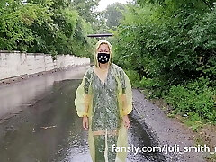 Nubile in yellow raincoat flashes pussy outdoors in the rain