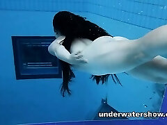Ultra-cute Umora is swimming nude in the pool