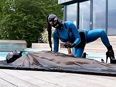 Cristal Kinky in latex catsuit – hand job and orgy with bound sub in latex vacbed Preview