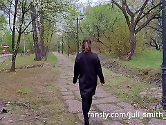 Hot girl in a very short dress walks in the park and flashes her pussy