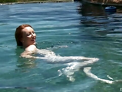 Redhead teen stunner Katy Kiss fellates and fucks by the pool outdoors