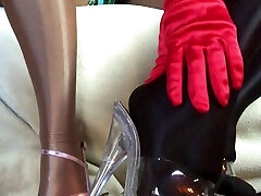 Sensuous teasing close up legs and feet in Shiny glossy pantyhose and high stilettos.