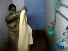Fat Indian girl washes her body in the bathroom in hidden web cam clip