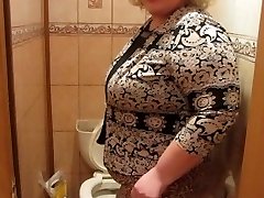 Mature woman with a hairy by a labia, urinating in the toilet)