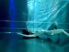 Bond Girl, underwater stunts, egghead girl, high high-heeled shoes glamor and underwater swimming retro style 