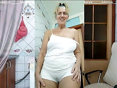 Lukerya in the kitchen in moist white panties, bottom view