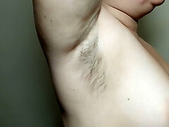 Ellie shows her hairy underarms and plays with them