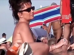 Naughty mature nudists at a beach