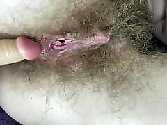Furry girl fucks her wet big clit pussy with fake penis in close up