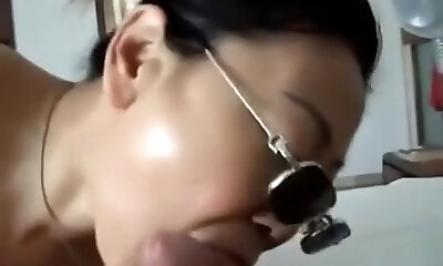 Asian girl with sunglasses sucks cock, while getting finger-banged.