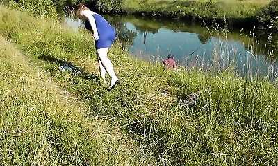 Nudist beach. Public nudity. Sexy MILF sans panties and bra sunbathes naked is not shy about fisherman. Naked in public. Milf