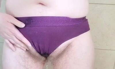 Wet dirty purple cotton underpants in tub