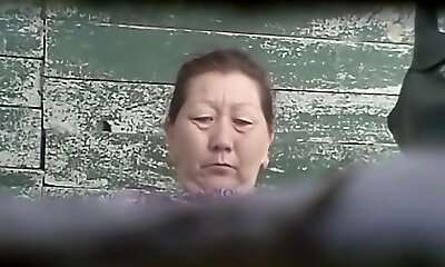 Hairy cooch of a mature Japanese lady in the public toilet room