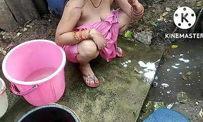 Indian house wife bathing outside