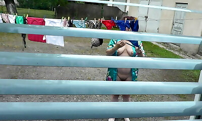 Naked in public. Neighbor saw pregnant neighbor in window who was drying clothes in yard sans brassiere and panties. Nudist