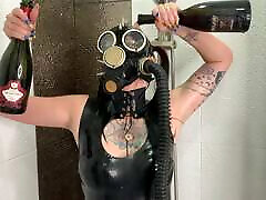Dominatrix Nika in a gas mask pours wine over her satin babydoll body. singer mms fetish