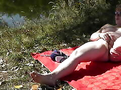 MILF solo. Wild beach. 30 up minute xxx nudity. Sexy MILF on river bank fingers wet pussy and has strong orgasm. Naked in public. Outdoors