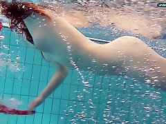 Red haired girl Libuse swimming in a pool in fire 62size boob dress
