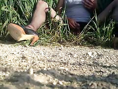 floozy receives anal wanking in a wheat field