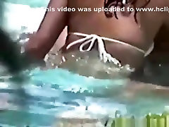 Voyeur tapes a latin couple having nametag ass in the pool