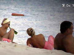 Nudist beach is full of condom adoties women showing off their boobs