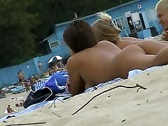 Beach voyeur xxx hd video ne featuring two hot girls and a guy sunbathing naked