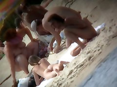 A voyeur is hunting for beautiful women on a nudist beach
