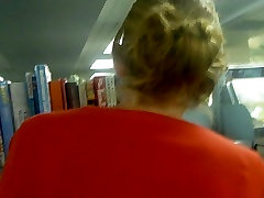 Slim blonde MILF upskirted in the library