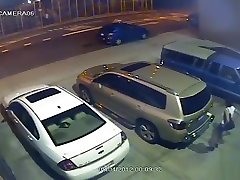 Security camera catches a big cok usa peeing behind a car