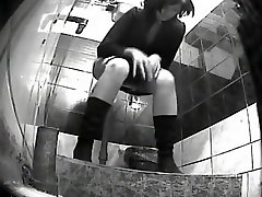 Spying a girl pissing at a public toilet