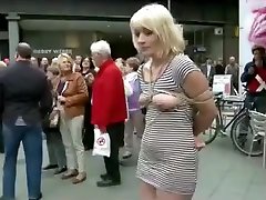 Submissive woman bound and exposed in public