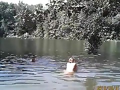Naked pregnant redhead out on the lake