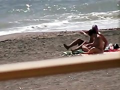 Nude hot ass brunette gives blowjob and hand job on the beach
