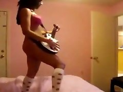 Chick plays Guitar Hero in a belt