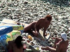 Amateur latex rubber men of Couple at a public beach nude