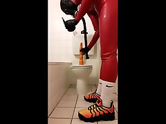 assplay in red rubber suit