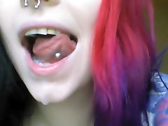 Goth girl plays with her mouth and spits