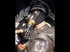 officer cigar smoke with gasmask in leather uniform gloves