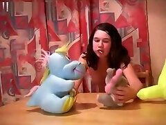Funny nude girl playing with dolls