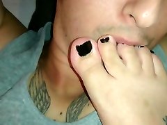 Giving a footjob while my asian rusian is licking my feet and toes.